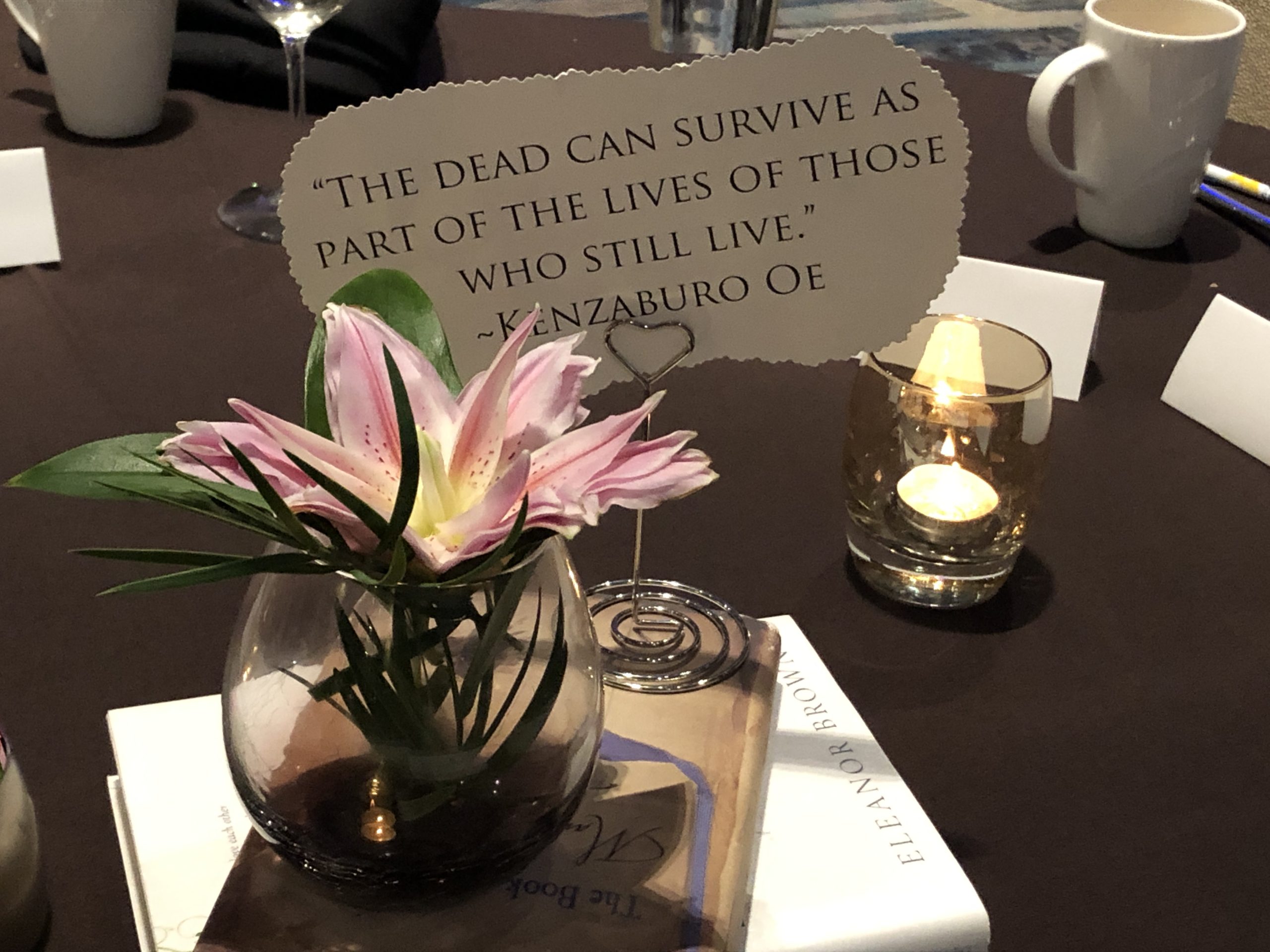 centerpiece with words reminding us that we do not leave our loved ones behind; we carry them with us.