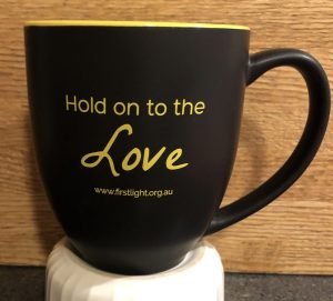 Coffee mug that says "Hold on to the Love."