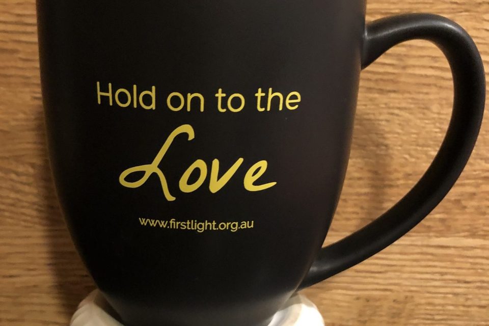 Coffee mug that says "Hold on to the Love."