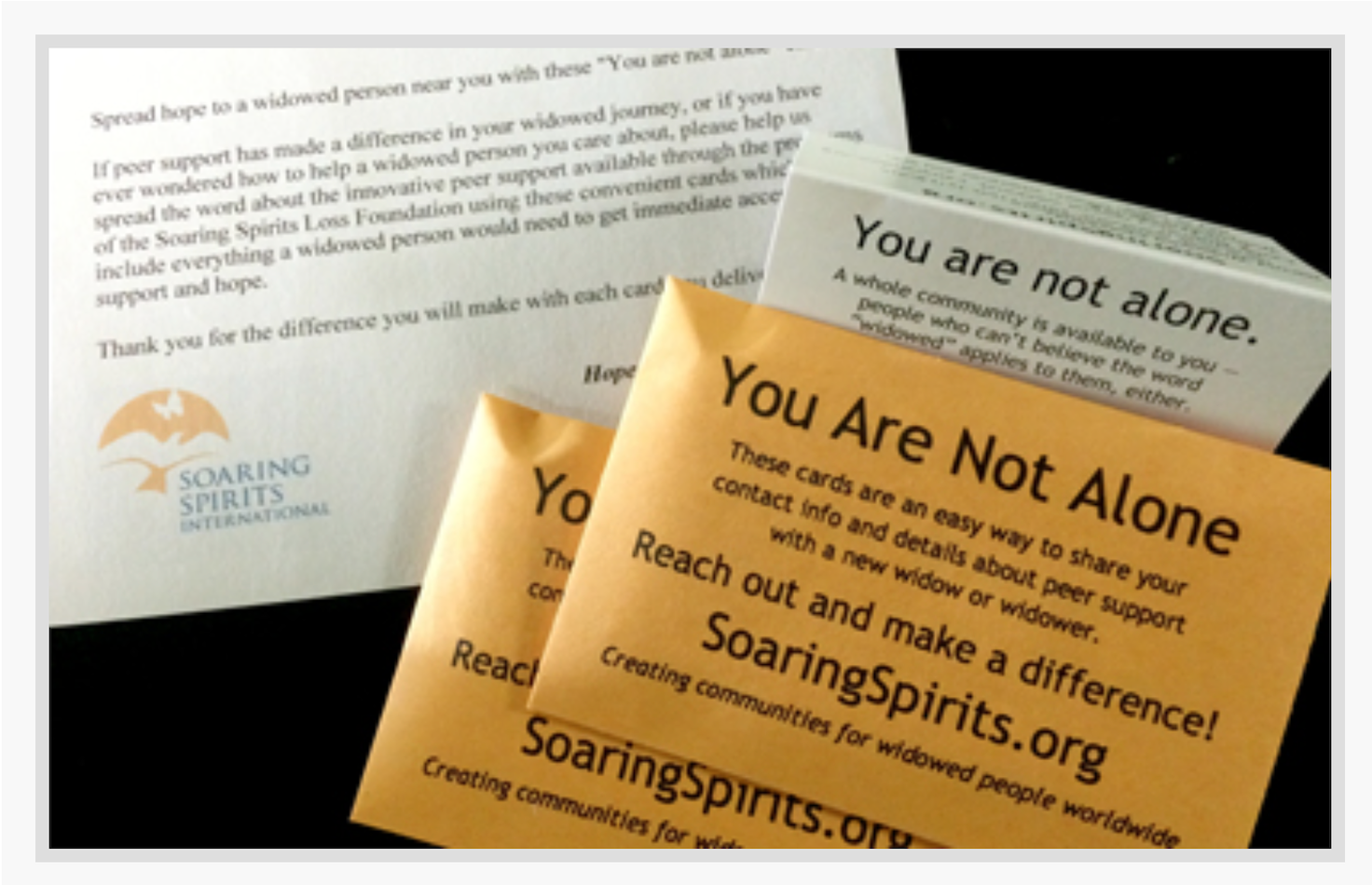 small envelopes that include information about Soaring Spirits International - You Are Not Alone