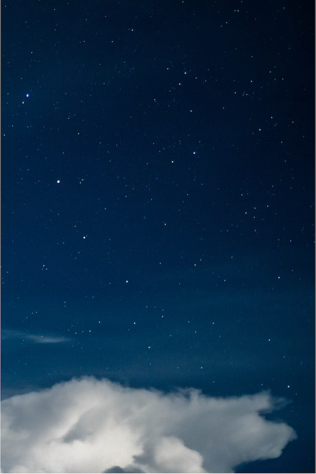 night sky full of stars with a cloud just below