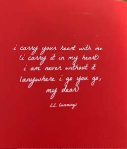 red book with quote by e.e. cummings