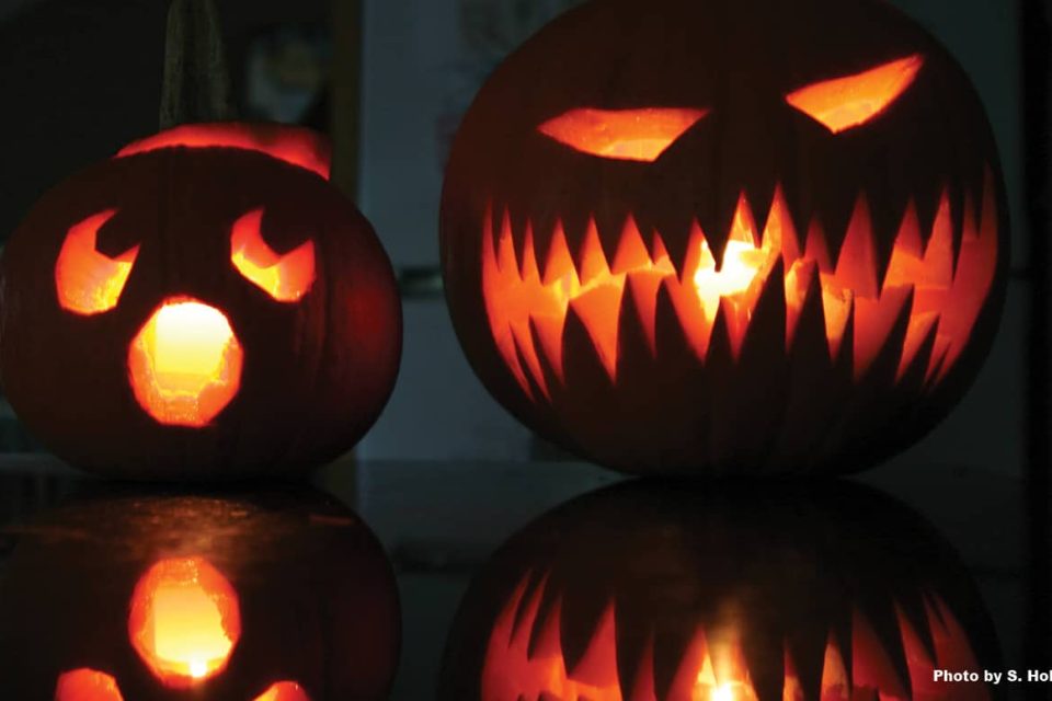 Two lit Halloween jack-o-lanterns