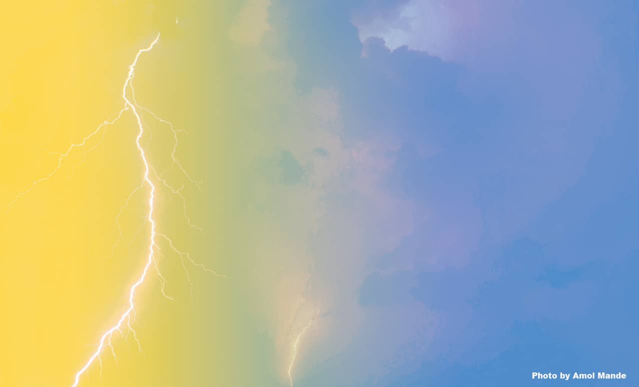 A photo of a natural lightening strike with a yellow to blue color gradient fade.