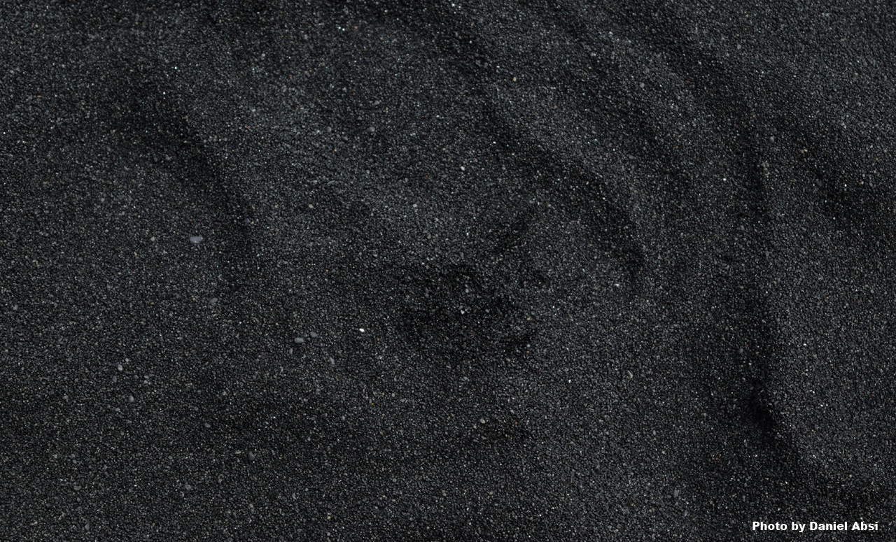 A close up of black sand
