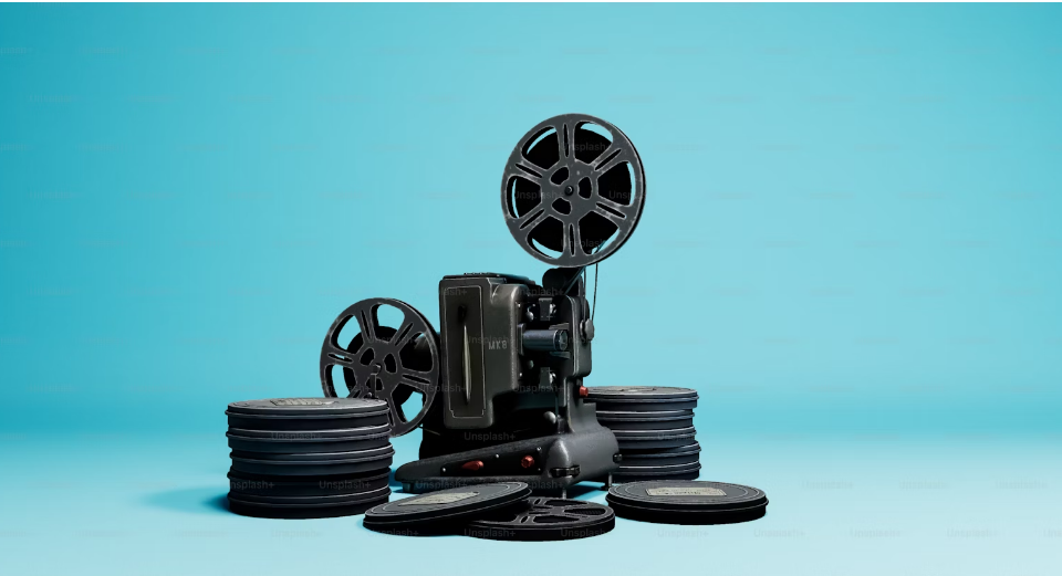 Movie camera with stacks of covered reels.