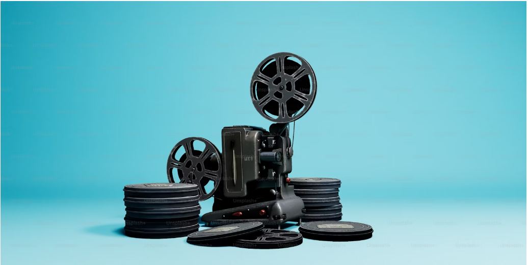 Movie camera with stacks of covered reels.