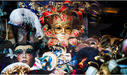 A pile of varying Mardi Gras masks.
