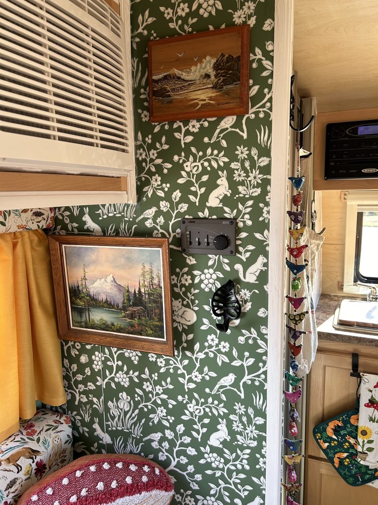 thrift store painting on the wall in a tiny trailer