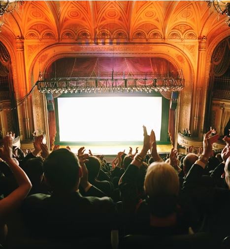 People clapping in a theater