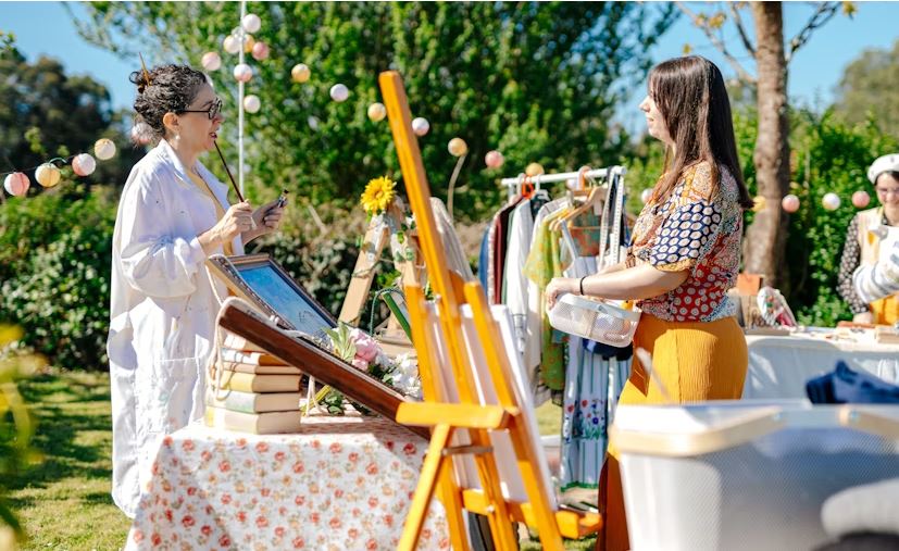 Women speaking at a yard sale.