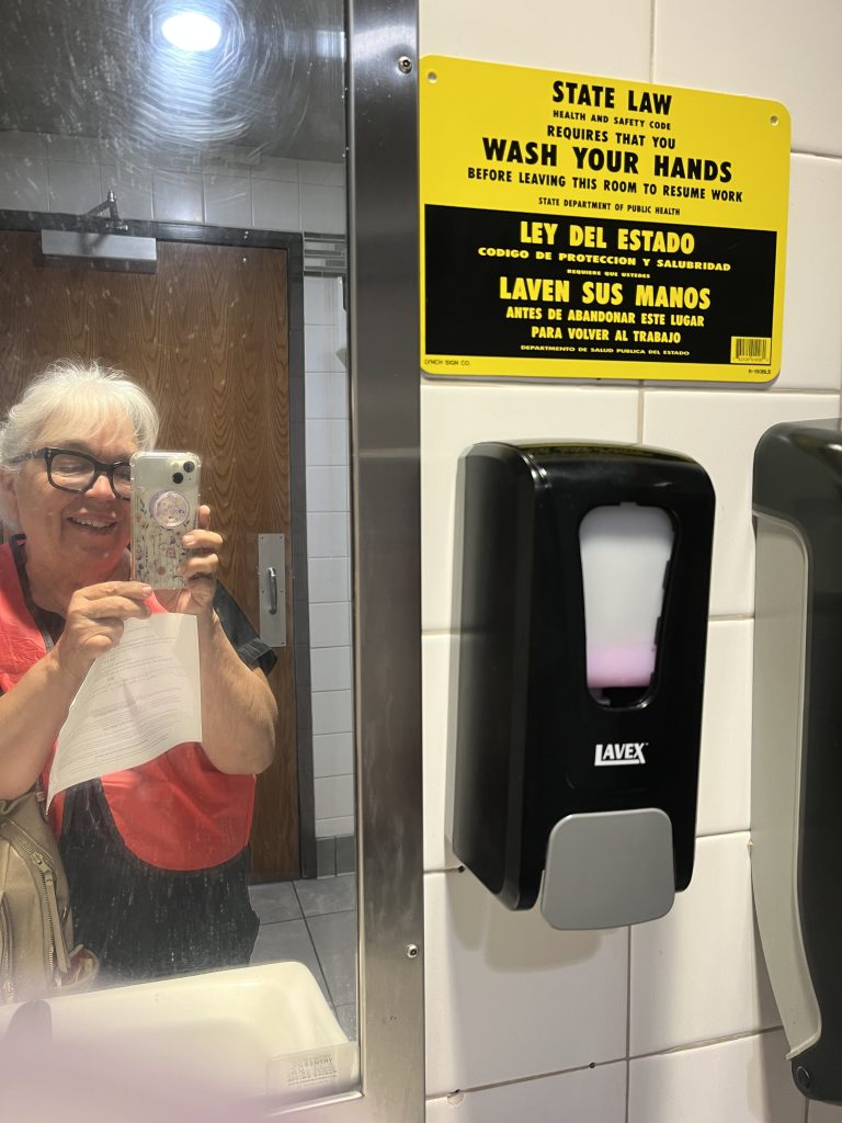 Woman in orange vest taking a selfie