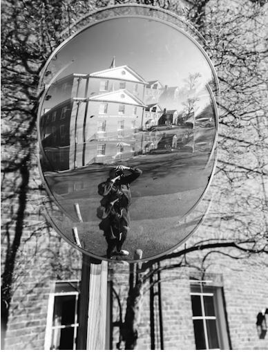 Life viewed through the mirror of film is shown with a mirror reflecting a person in double exposure.